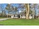 Charming single-story home with a well-maintained lawn and mature trees at 5960 John St, Austell, GA 30106