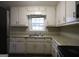 Efficient kitchen featuring ample cabinetry and stainless steel appliances at 5960 John St, Austell, GA 30106