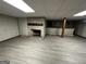 View of the finished basement featuring vinyl flooring and a brick fireplace with a bar area at 2760 The Fontainebleau Sw, Atlanta, GA 30331
