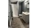 The updated bathroom features a standing shower, vanity, and modern vinyl flooring at 2760 The Fontainebleau Sw, Atlanta, GA 30331