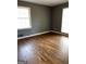 Cozy bedroom featuring hardwood floors, freshly painted walls, and natural light from large windows at 2760 The Fontainebleau Sw, Atlanta, GA 30331