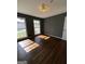 Bedroom featuring hardwood floors, freshly painted walls, and natural light from large windows at 2760 The Fontainebleau Sw, Atlanta, GA 30331
