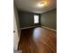 Bedroom featuring refinished hardwood floors, painted walls, and window at 2760 The Fontainebleau Sw, Atlanta, GA 30331