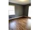 Bright bedroom featuring hardwood floors, freshly painted walls, and natural light from large windows at 2760 The Fontainebleau Sw, Atlanta, GA 30331