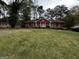Traditional red brick home featuring a large front lawn and mature trees at 2760 The Fontainebleau Sw, Atlanta, GA 30331