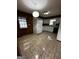 Functional kitchen with white cabinets, tiled floor, and wood paneled walls at 2760 The Fontainebleau Sw, Atlanta, GA 30331