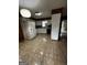 Functional kitchen with white cabinets, tiled floor, and wood paneled walls at 2760 The Fontainebleau Sw, Atlanta, GA 30331