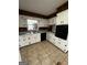 Well-lit kitchen featuring white cabinets and black appliances at 2760 The Fontainebleau Sw, Atlanta, GA 30331
