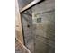Shower with glass door, silver hardware and marble-style tile at 2760 The Fontainebleau Sw, Atlanta, GA 30331