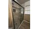 Bathroom featuring a tiled shower with a glass door, window, and tile accents at 2760 The Fontainebleau Sw, Atlanta, GA 30331