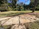 Spacious backyard view with a concrete patio leading to a well-maintained grassy lawn and mature trees at 2502 Miriam Ln, Decatur, GA 30032