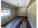 Finished basement area with gray vinyl flooring, painted paneling, and a bright window for natural light at 2502 Miriam Ln, Decatur, GA 30032