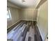 A finished basement showcasing paneled walls, window, and vinyl wood flooring at 2502 Miriam Ln, Decatur, GA 30032
