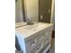 Bathroom vanity with drawers, a white sink, and fixtures with a large mirror at 2502 Miriam Ln, Decatur, GA 30032