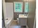 A bathroom featuring a bathtub, toilet, and a vanity with a white sink at 2502 Miriam Ln, Decatur, GA 30032