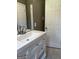 Bathroom vanity with drawers, a white sink, and fixtures with a large mirror at 2502 Miriam Ln, Decatur, GA 30032