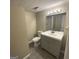 Cozy bathroom features a gray vanity, white toilet, tile floors, and a shower with glass door at 2502 Miriam Ln, Decatur, GA 30032