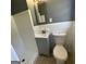 Cozy bathroom with tiled shower, sink, and toilet featuring gray paint and white tile backsplash at 2502 Miriam Ln, Decatur, GA 30032