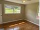 This bedroom has hardwood floors, two windows letting in light, and neutral walls for a modern feel at 2502 Miriam Ln, Decatur, GA 30032