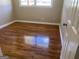 Bright bedroom with gleaming hardwood floors and a large window at 2502 Miriam Ln, Decatur, GA 30032