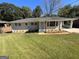 Charming brick home features a beautifully landscaped front yard and a covered carport, perfect for outdoor living at 2502 Miriam Ln, Decatur, GA 30032