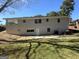 Back exterior of the home showing a covered patio and the grassy backyard at 2502 Miriam Ln, Decatur, GA 30032
