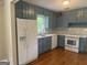 Updated kitchen with white appliances, new backsplash, quartz counters and gray painted cabinets at 2502 Miriam Ln, Decatur, GA 30032