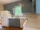 Updated kitchen with white appliances, new backsplash, quartz counters and gray painted cabinets at 2502 Miriam Ln, Decatur, GA 30032
