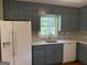 This kitchen is equipped with stainless steel appliances and blue cabinetry at 2502 Miriam Ln, Decatur, GA 30032