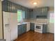 Updated kitchen with white appliances, new backsplash, quartz counters and gray painted cabinets at 2502 Miriam Ln, Decatur, GA 30032