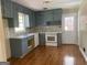 Modern kitchen features gray cabinets, white appliances, quartz countertops, and stylish backsplash at 2502 Miriam Ln, Decatur, GA 30032