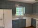 This kitchen is equipped with stainless steel appliances and blue cabinetry at 2502 Miriam Ln, Decatur, GA 30032