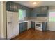Updated kitchen with white appliances, new backsplash, quartz counters and gray painted cabinets at 2502 Miriam Ln, Decatur, GA 30032
