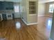 Modern kitchen view leading to a bright dining room with hardwood floors and a built-in shelving at 2502 Miriam Ln, Decatur, GA 30032