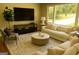 Bright living room with large windows, a neutral sofa, stylish coffee table, and modern entertainment center at 2502 Miriam Ln, Decatur, GA 30032