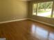 Spacious living room featuring gleaming hardwood floors and a large window with neighborhood views at 2502 Miriam Ln, Decatur, GA 30032