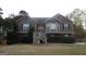 Charming two-story home featuring wood and brick, a landscaped yard, and a welcoming front entrance at 1742 Pine Fort Cir, Dacula, GA 30019
