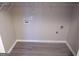 Bright laundry room with new vinyl plank flooring and white shelving perfect for organizing at 1742 Pine Fort Cir, Dacula, GA 30019
