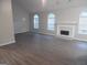 Spacious living room with sleek flooring, a fireplace and large, arched windows at 1742 Pine Fort Cir, Dacula, GA 30019