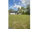 Spacious backyard with lush green lawn, white home, and wooded backdrop at 2112 Highway 54, Moreland, GA 30259