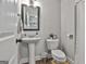 Cozy bathroom with a pedestal sink, toilet, and neutral color scheme at 2112 Highway 54, Moreland, GA 30259