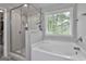 Modern bathroom with a luxurious shower, separate bathtub, and natural light at 2112 Highway 54, Moreland, GA 30259