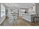 Bright dining room with hardwood floors, a decorative chandelier, and views into the open kitchen at 2112 Highway 54, Moreland, GA 30259