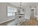 Cozy dining area bathed in natural light, boasting hardwood floors and a modern chandelier at 2112 Highway 54, Moreland, GA 30259