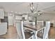 A modern, open floor plan showcasing the dining room adjacent to the kitchen and living room areas at 2112 Highway 54, Moreland, GA 30259