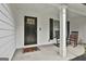 Inviting front porch with rocking chairs and a stylish door, offering a cozy and welcoming entrance at 2112 Highway 54, Moreland, GA 30259