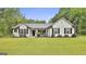 Charming white home featuring black shutters, a well-manicured lawn, and inviting landscaping for curb appeal at 2112 Highway 54, Moreland, GA 30259