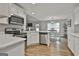 Beautiful kitchen featuring stainless steel appliances, quartz countertops, and wood flooring at 2112 Highway 54, Moreland, GA 30259