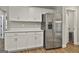 Spacious kitchen featuring white cabinets, quartz countertops, and stainless steel refrigerator at 2112 Highway 54, Moreland, GA 30259