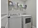 Convenient laundry room with modern washer and dryer and storage shelving at 2112 Highway 54, Moreland, GA 30259